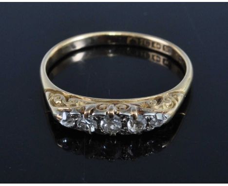 A Victorian 18ct gold diamond five stone ring, the graduated old cuts in a carved line setting, Birmingham 1871, 2.6g, size P