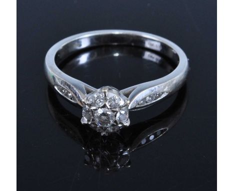 A contemporary 18ct white gold diamond cluster ring, the shoulders further set with three diamond highlights to either side, 