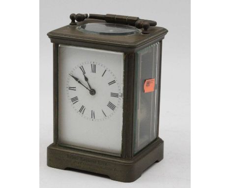 A late Victorian lacquered brass cased carriage clock having an enamel dial with visible platform lever escapement and barrel