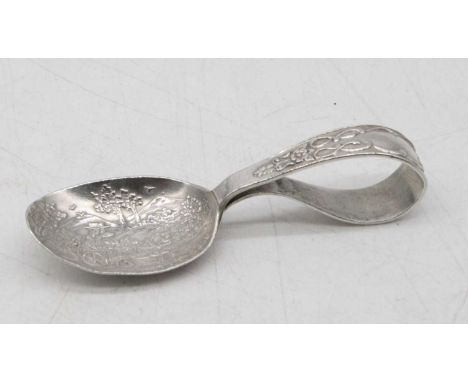 An Edwardian silver baby's feeding spoon, the oval bowl embossed with a dog in a cart being drawn by a donkey within a landsc
