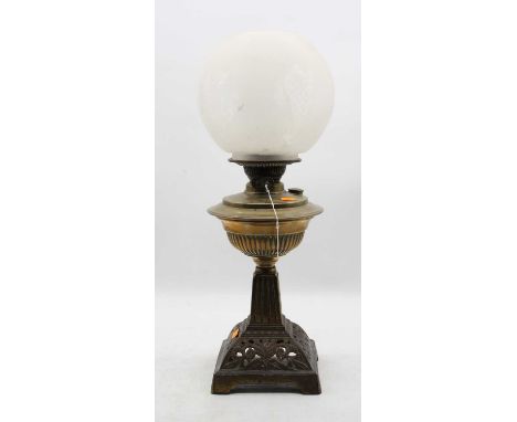 A Victorian oil lamp, having opalescent globular shade above a brass font, on a pierced iron base, h.53cm