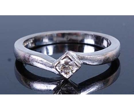 An 18ct white gold diamond solitaire ring, comprising a round brilliant cut diamond in a semi-bezel crossover setting, diamon