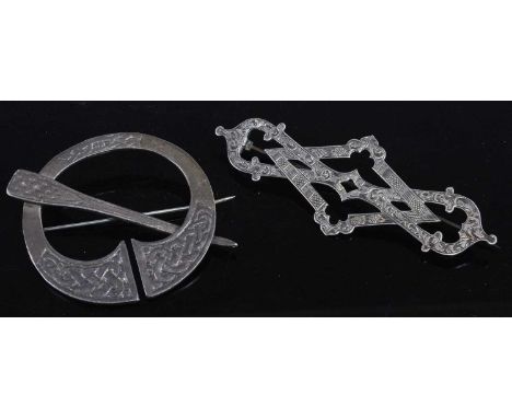 A Celtic style silver buckle brooch, 52mm together with a white metal and engraved lozenge brooch, 8.5cm (2)