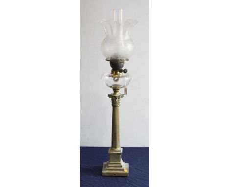 A Victorian pedestal oil lamp, having an etched frilled glass shade above a clear glass font, on a brass Corinthian column an