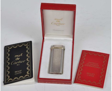 A Must de Cartier Briquet steel and gold cigarette lighter, in fitted box with papers