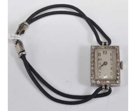 An Art Deco platinum cased diamond set ladies cocktail watch, the silver dial with Arabic numerals, manual wind movement, and