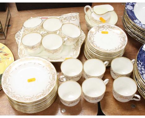 A Wedgwood part tea and dinner service, the white ground with gilt bell-flower and scrolling decoration, pattern No.4482