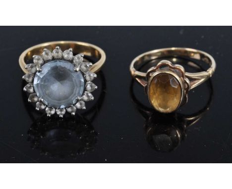 A 9ct gold and citrine set dress ring, size M; together with a yellow metal, blue topaz and white stone set dress ring, size 