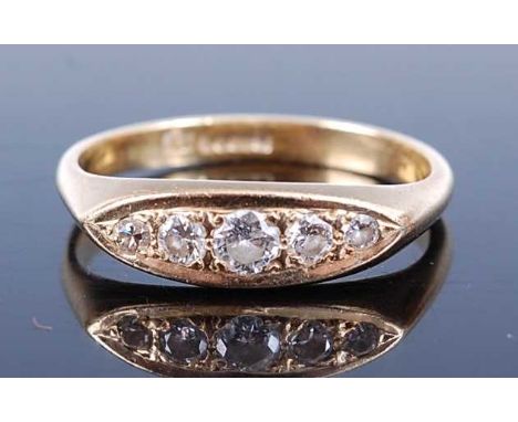 An 18ct yellow gold diamond five stone half hoop eternity ring, comprising five graduated round brilliant cut diamonds grain 