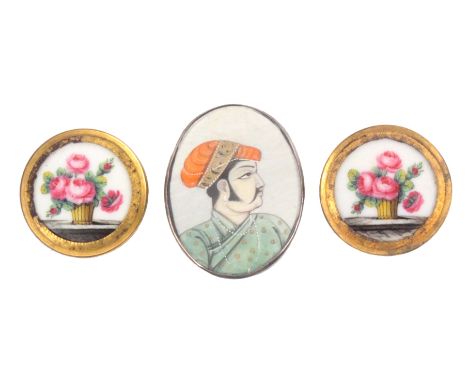 Buttons - three, comprising a pair of 18th Century buttons, the centres painted with a vase of flowers on a table top in gilt