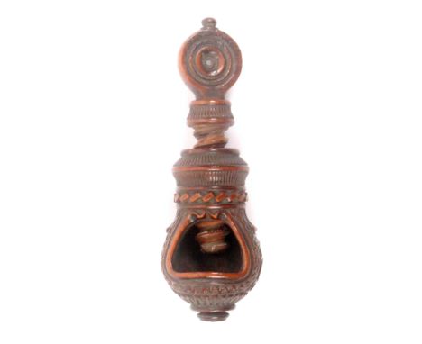 A late 18th/early 19th Century screw form nut cracker, continental, the body elaborately carved with circles, flutes, gadroon