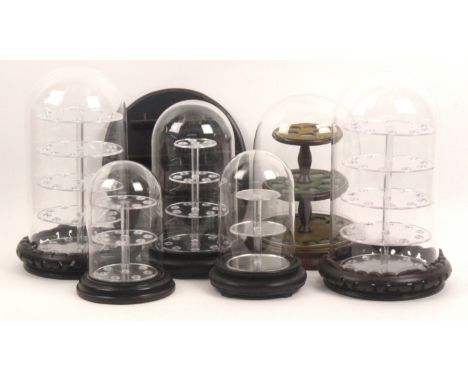 Thimble stands and display units, comprising six glass and plastic domes, various shelf units and two glazed frame cabinets.&