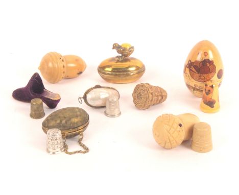 Eight thimble stands and cases, comprising a velvet shoe with leather sole, 5.5cms, an oval brass egg surmounted by chick wit