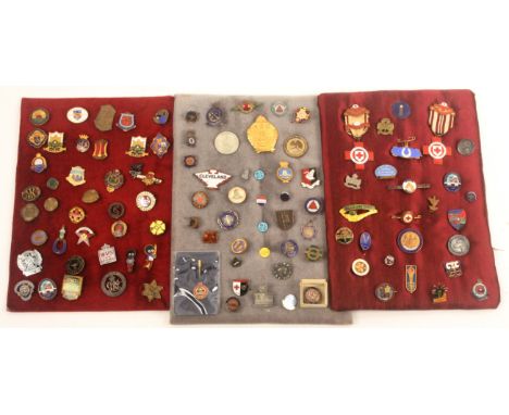 Enamel lapel badges, brooches and medals, comprising three displays totalling sixty examples, and a further selection of fort