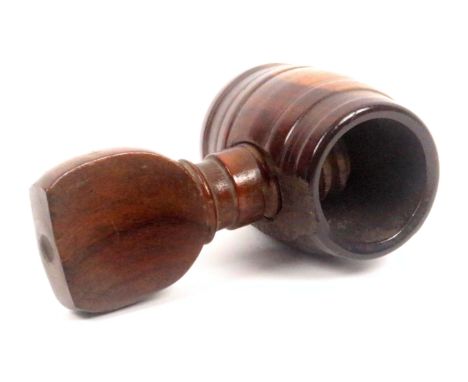 A late 18th, early 19th Century screw form nut cracker, probably lignum vitae, barrel form body with side screw, some old los