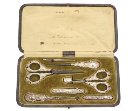 A silver eight piece sewing set contained in a leatherette rectangular case, circa 1900, the case with green velvet flush fit