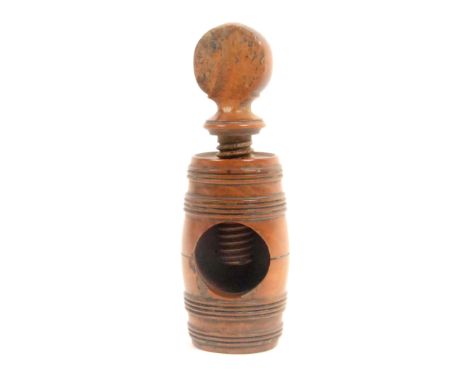 A late 18th, early 19th Century boxwood screw form nut cracker, the barrel form body with top screw, 9.5cms high.&nbsp; 