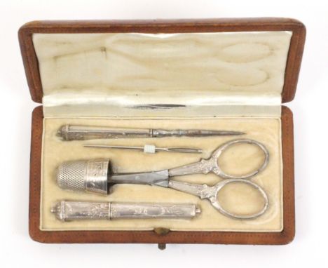 A continental five piece silver sewing set in a brown leather rectangular case, circa 1910, the case interior in cream silk o