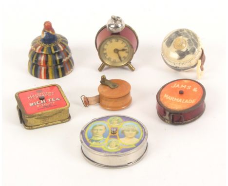 Seven tape measures, comprising a box wood, drum form example, a wooden box form example as a woman in traditional costumer w