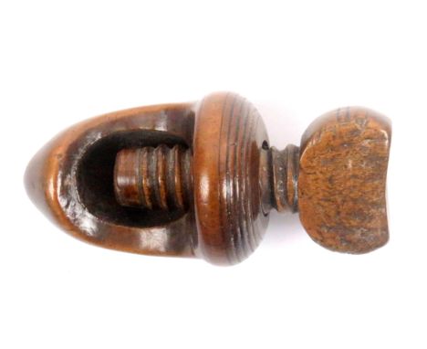 A late 18th/early 19th Century screw form nut cracker, fruitwood, the acorn form body below a top screw, 7cms.&nbsp; 