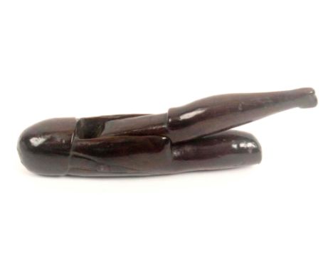 A 17th Century scissor form figural nut cracker, English, the dense and well patinated timber carved at the opening with the 