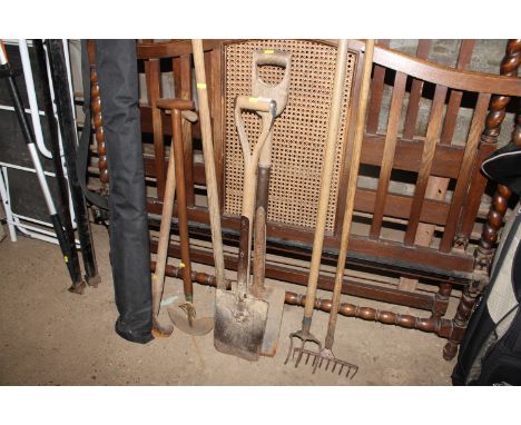 A collection of various garden tools and a spirit level