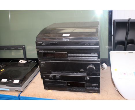 A Kenwood stack comprising turntable, stereo synthesiser tuner, integrated amplifier, cassette deck and a compact disc player