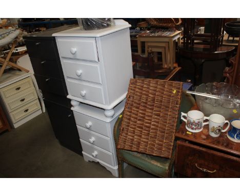 A pair of painted pine bedside chests fitted with three drawers, a loom chair, wicker basket and two waste bins
