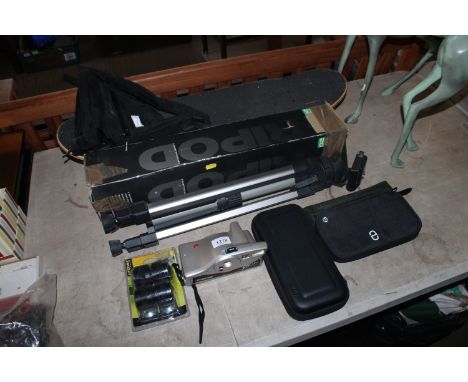 A camera tripod; a Nintendo Switch case; a Polaroid camera; skateboard etc.