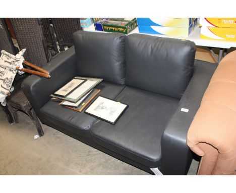 A black leatherette upholstered two seater settee