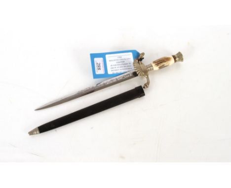 A Decorative German hunting dagger with etched blade and classic cam shell cross guard. This item can only be purchased by so