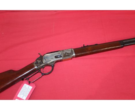 A Model 1873 lever action Winchester style rifle by Uberti. 24¼" octagonal barrel in 32/20 Cal. Ser. No.W78374, in overall ex