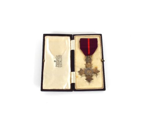 A cased Military O.B.E. (military) with First Type Britannia centre (Hallmarked London 1922) and within fitted Garrard &amp; 