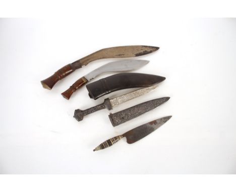 Two Kukri, with two other ornate knives. This item can only be purchased by someone over the age of 18 and ID verification ma