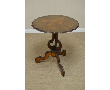 A 19th Century Continental walnut Occasional Table with shaped circular top on three shaped supports and tripod base, 2ft 2in