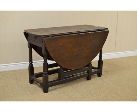 An 18th Century oak oval Gate-leg Table fitted end drawer on turned and square supports united by square stretchers, 3ft 6in 