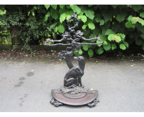 A cast iron Stick Stand with naturalistic design of a dog sat beside a leafy tree with inscription "Cave Canem", 2ft 6in H