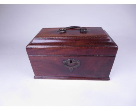 A George III mahogany Tea Caddy of sarcophagus shape with brass carrying handle and escutcheon, three interior tin cannisters