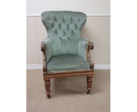 A William IV mahogany Easy Chair with button upholstered back, scrolled arms, on reeded tapering front supports and casters
