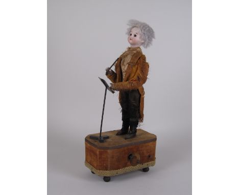 A 19th Century Musical Automaton in the form of a conductor having moving head and arm, bisque headed, dressed in silk tailco
