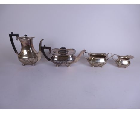 An Edward VII silver four piece Tea and Coffee Service of semi-fluted oblong form on ball feet, London 1908, 59oz all in