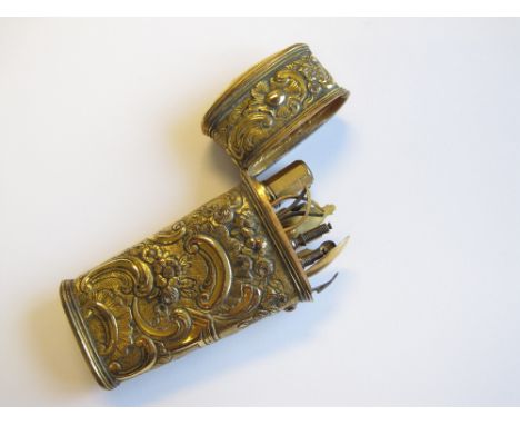 A 19th Century embossed gilt metal Necessaire Etui containing spoon, scissors, needlecase, etc, some tools associated, one mi