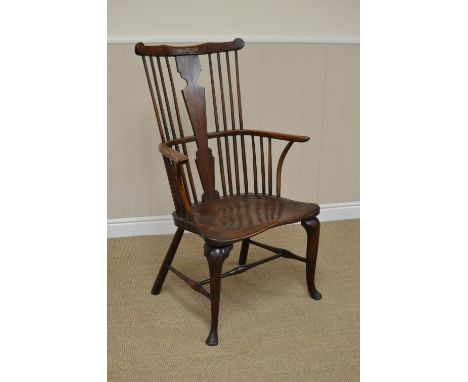 An 18th Century Thames Valley Windsor comb back Armchair, the shaped crest rail above an elm silhouette splat and outswept ar