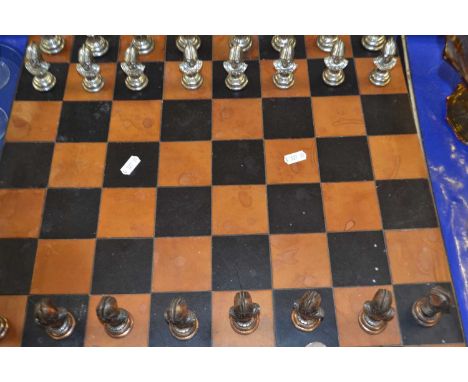 Modern metal chess set and accompanying board