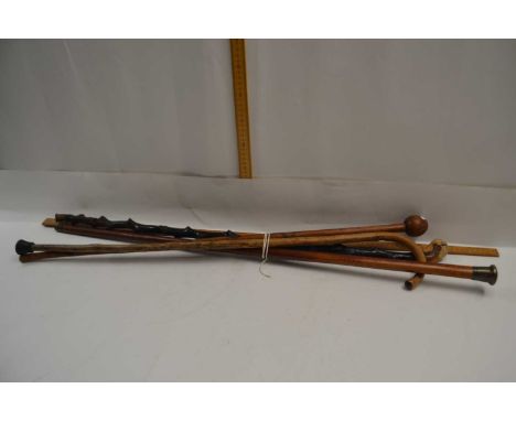 Mixed Lot: Walking sticks to include a Knobkerrie type example, a further white metal topped example and others