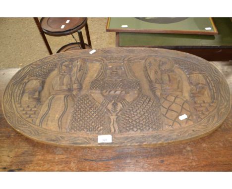 An African oval carved panel, 78cm wide