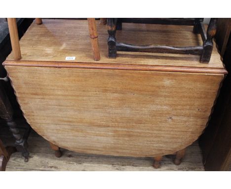 A 1920's light oak barley twist gate leg table