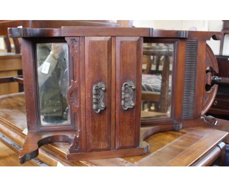 An Edwardian mahogany wall hanging mirror with two drawers and shelf