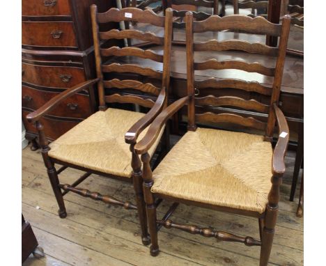 A pair of oak rushed seat ladder back carvers