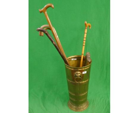 Brass walking stick stand together with walking sticks 